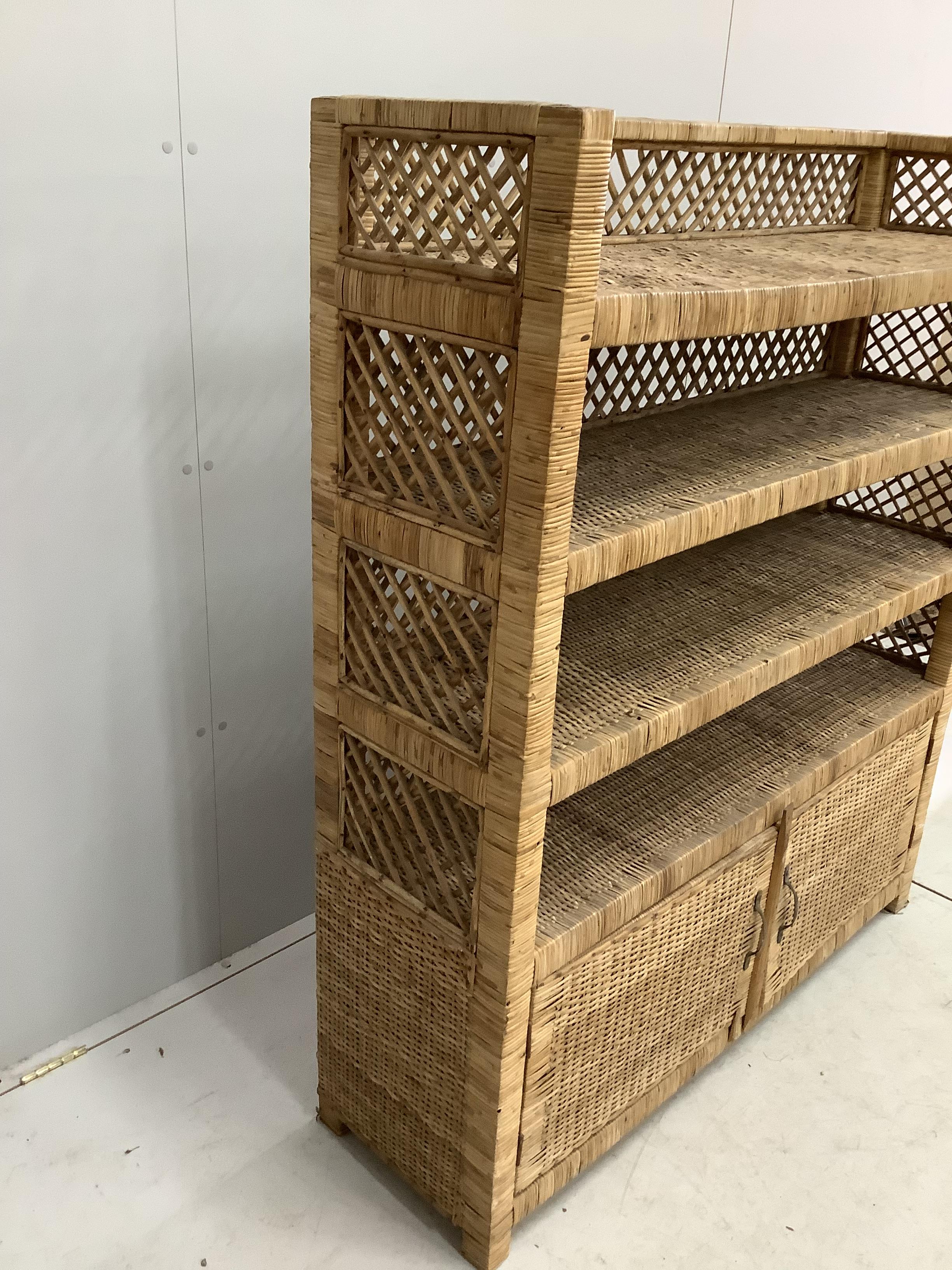 A wicker four tier shelf unit, width 121cm, depth 36cm, height 140cm, together with a wicker eight division tray
